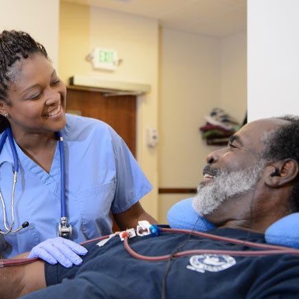 Dialysis technician and patient at a Fresenius Kidney Dialysis Center.