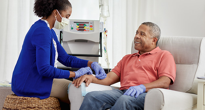 a nurse performing dialysis on a patient
